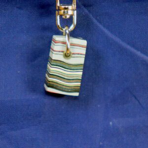Colorful striped keychain pendant on blue fabric