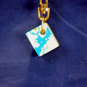 Square blue-and-white enamel charm on clasp