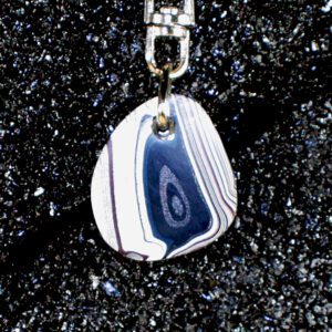 Striped teardrop pendant on black glitter