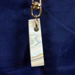 Marbled rectangular pendant keychain on navy background