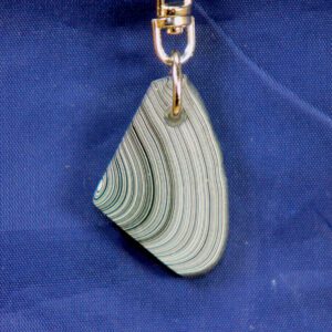 Layered striped teardrop pendant on blue background