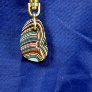 Colorful striped pendant keychain on blue background