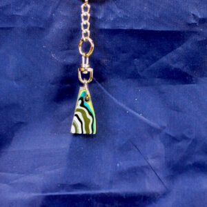 Colorful striped triangular keychain pendant on blue