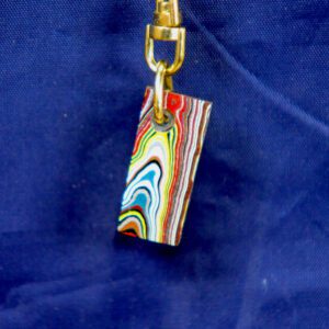 Multicolored layered pendant on blue background