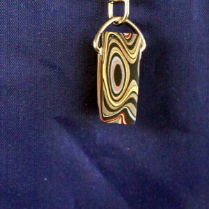 Swirled multicolor pendant on navy fabric